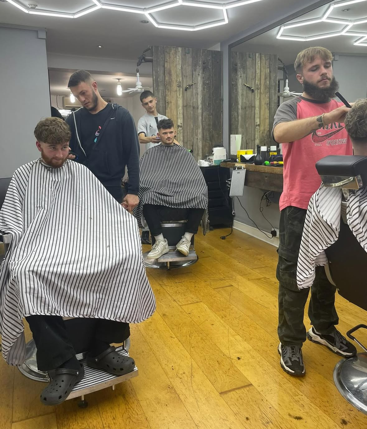 Barbers cutting hair at Lorenzo's Barbershop
