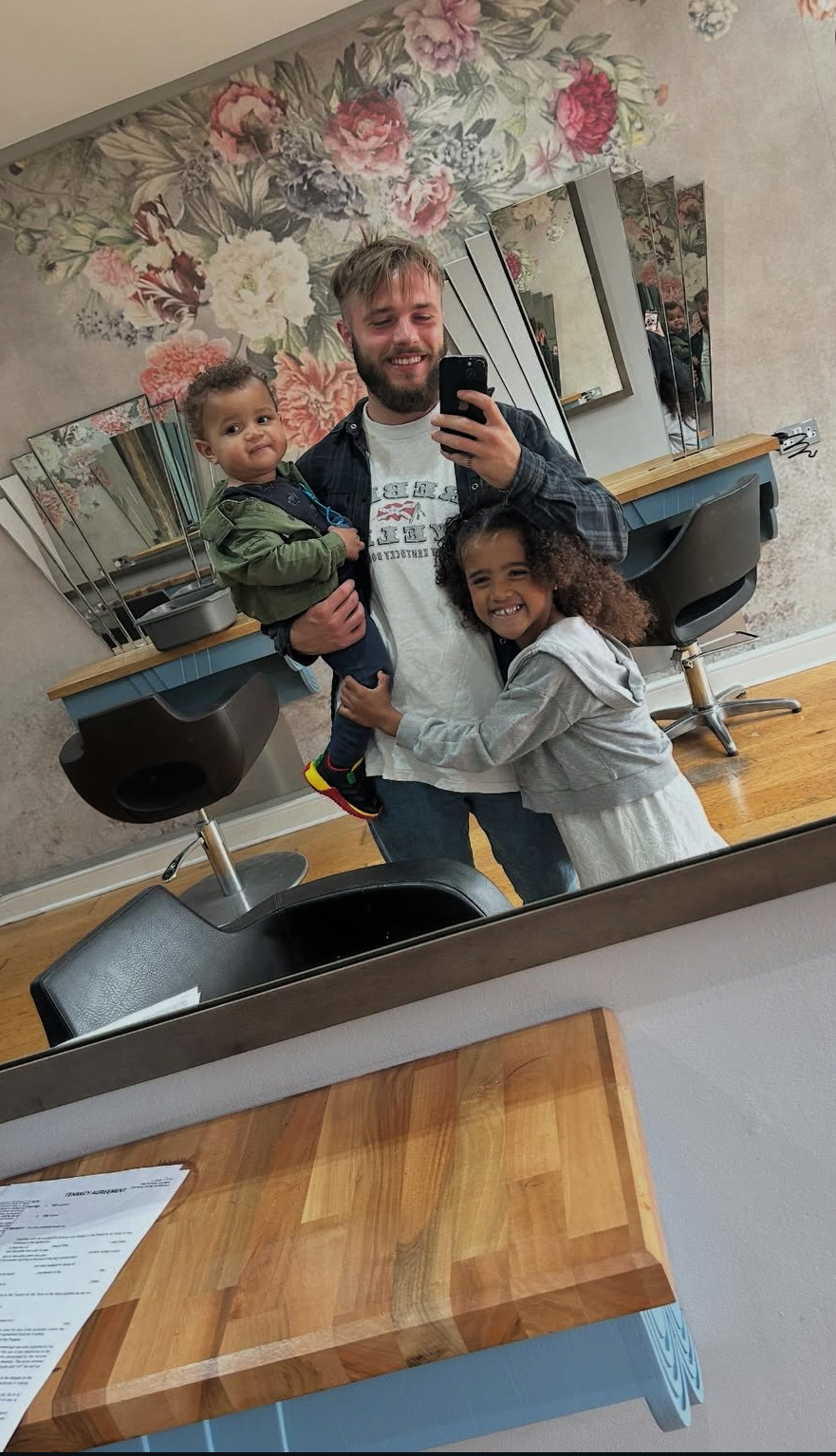 Lorenzo with his children in the shop